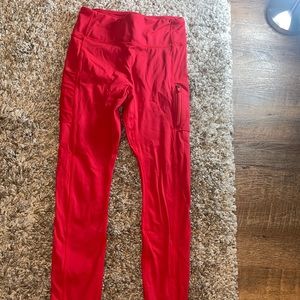 Red fabletics legging with zipper on bottom of each leg. Size Large
